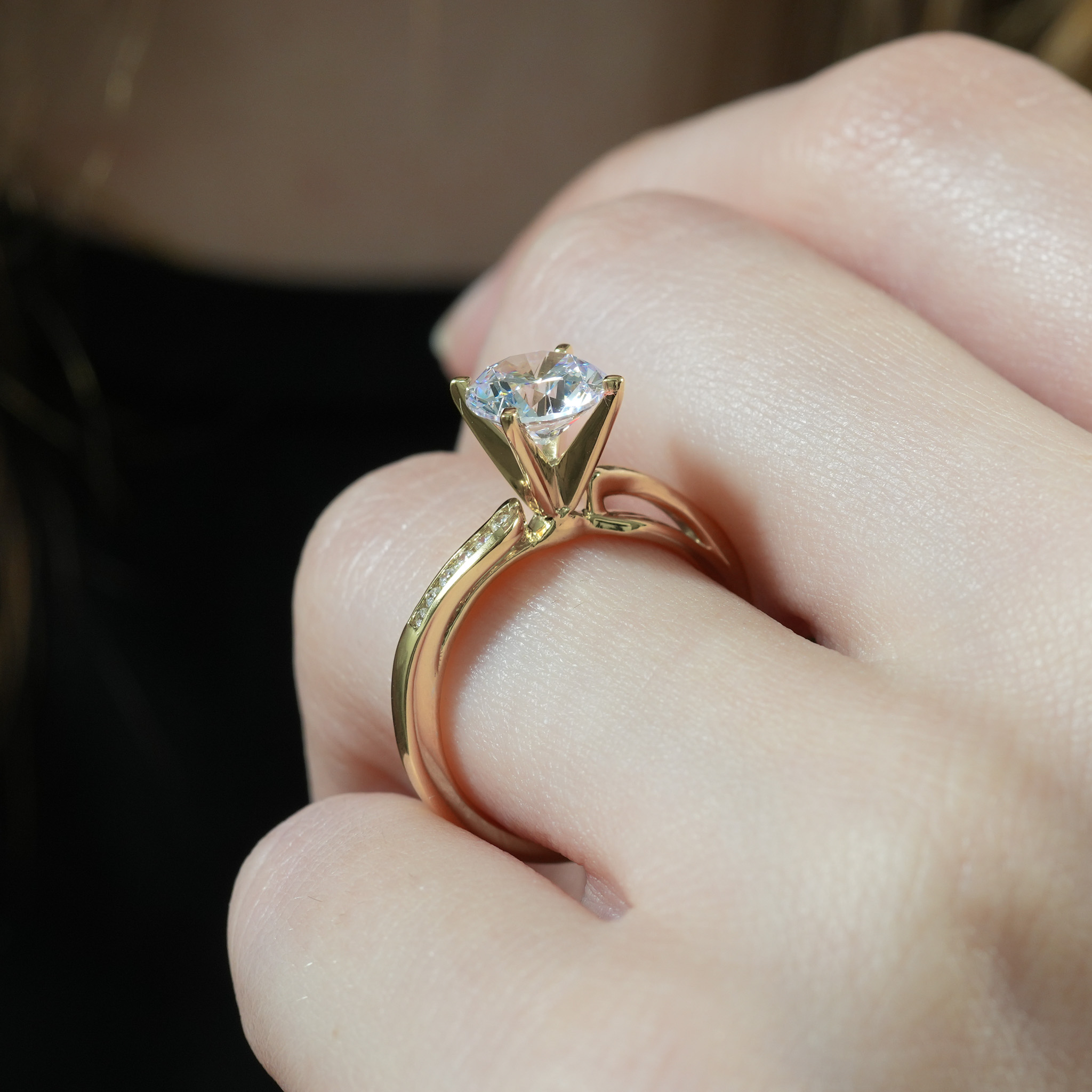 Angle view of ribbon engagement ring in lifestyle