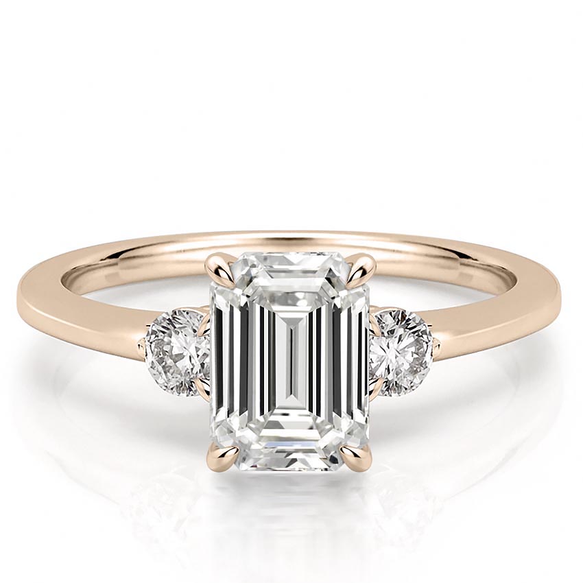 three-stone-emerald-engagement-ring in rose gold