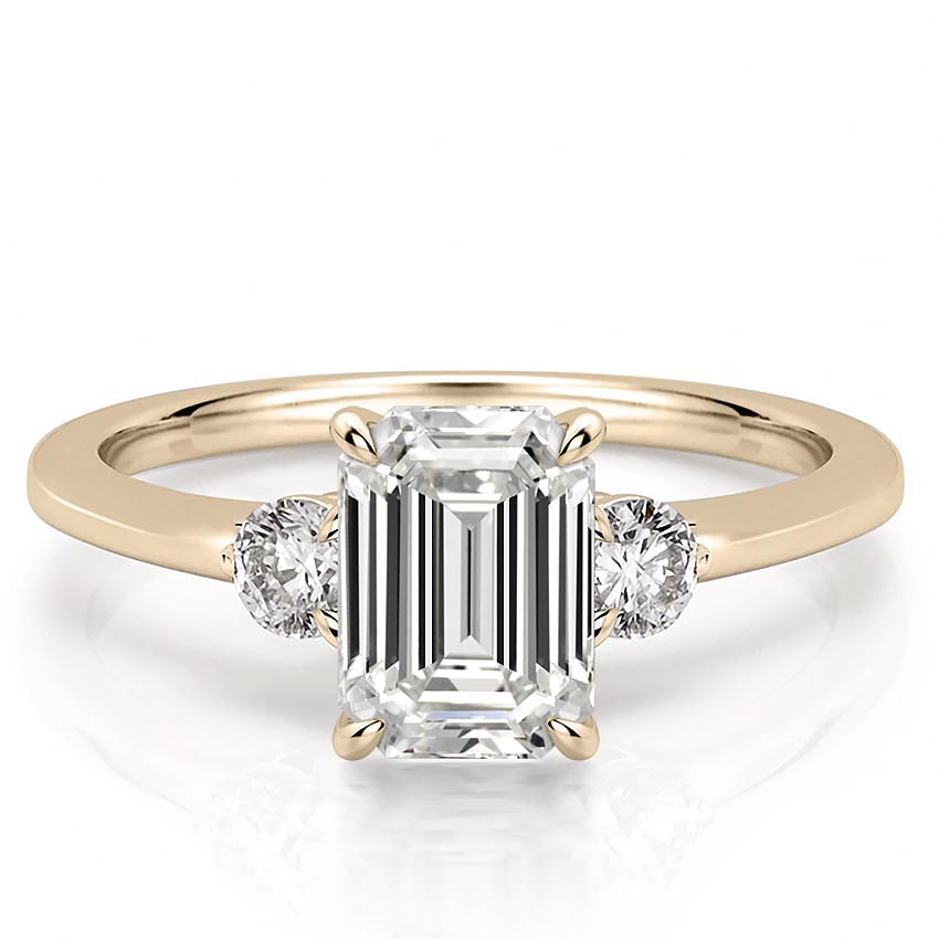 three-stone-emerald-engagement-ring in yellow gold