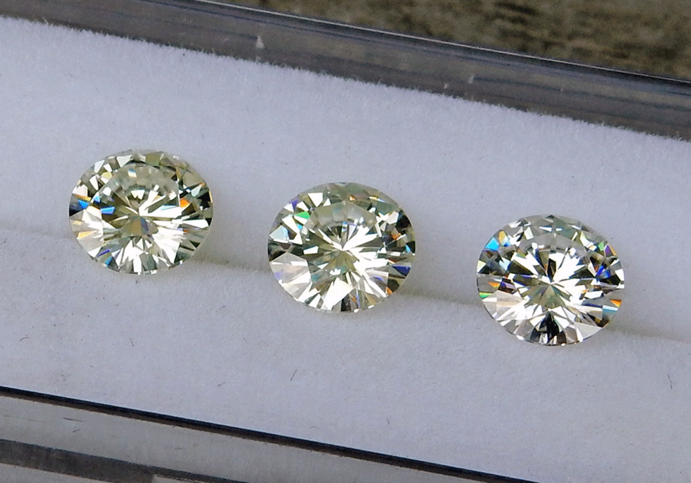 Side by side comparison of Classic Moissanite vs Near Colorless Moissanite vs Colorless Forever One Moissanite