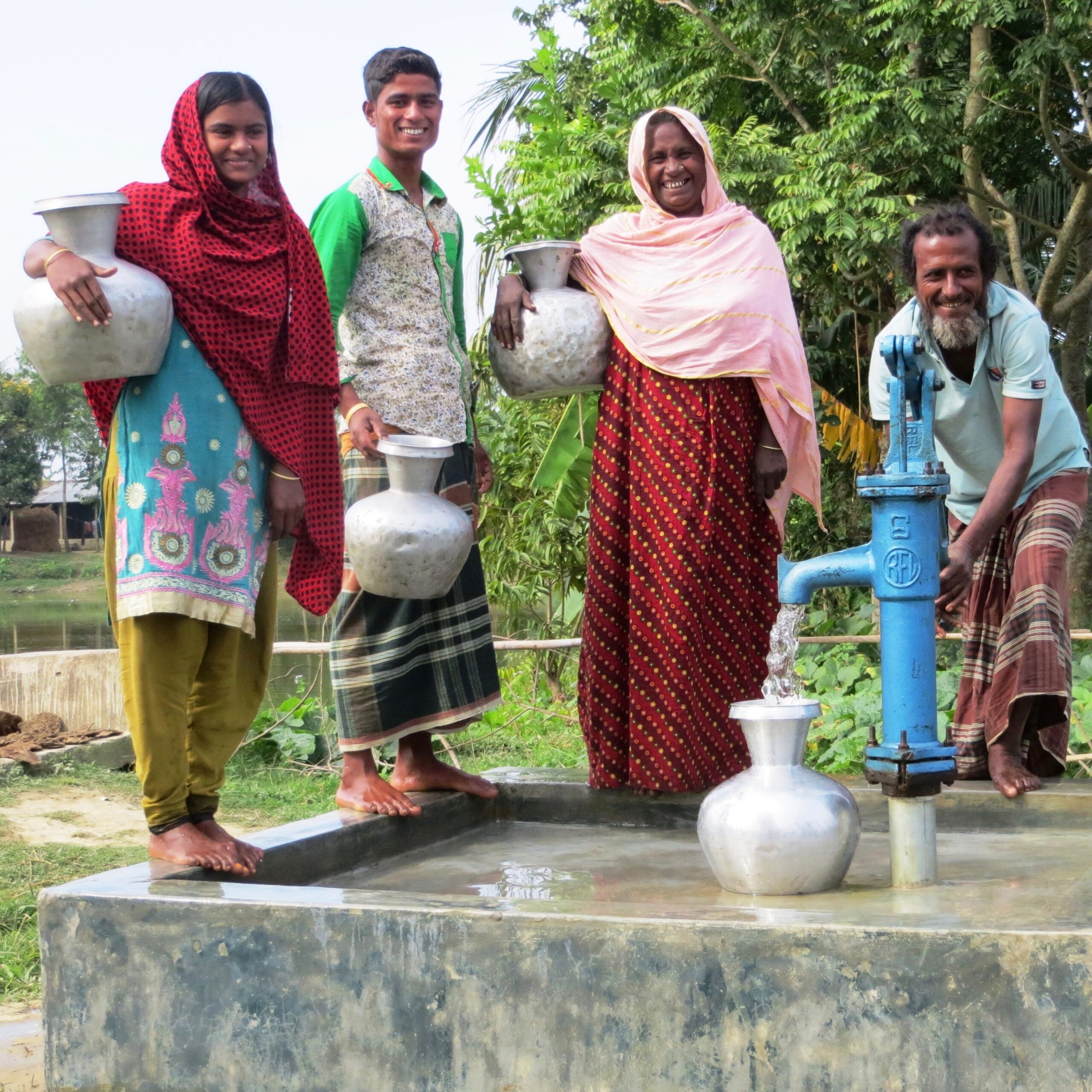 man pumping water into silver canteen