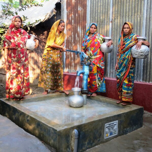 Four-People-Around-Water-Pump-Shamborpara-Dakshin-Raji-scaled