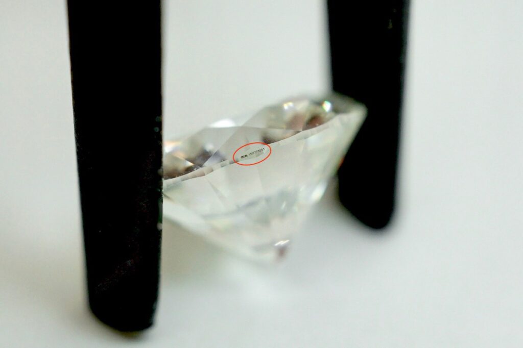 loose diamond with inscription on edge of diamond