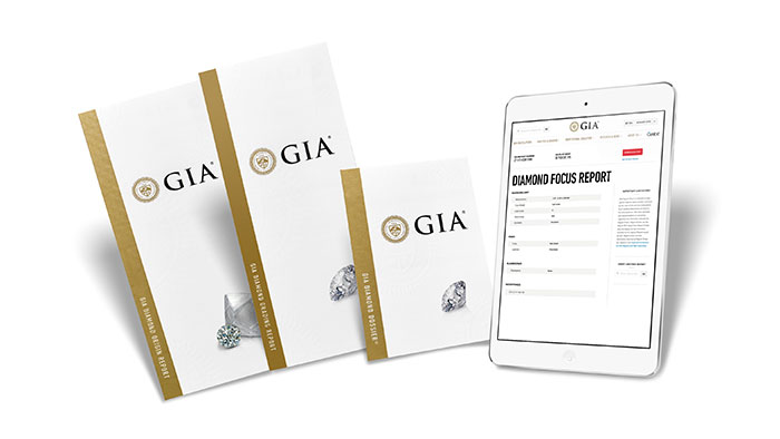 three GIA pamphlets and a tablet showing diamond reports