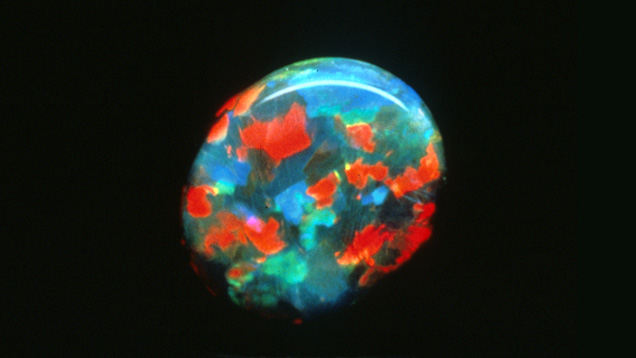 bright red, green and blue pattern on black opal