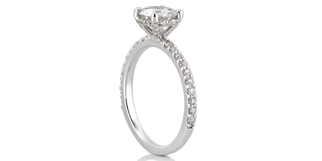 side stone classic engagement ring with diamond basket in white gold