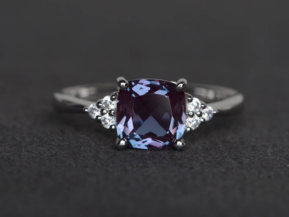 engagement ring with cushion cut alexandrite and side diamonds in white gold