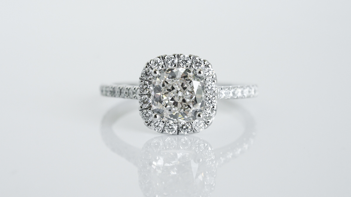 Round cut diamond with cushion halo clearance