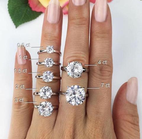 round engagement rings on hand in different carat weights for diamond grading