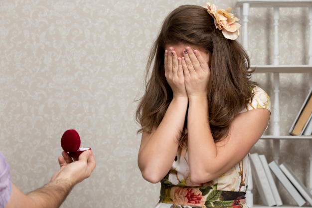 engagement ring box and girl covering eyes during proposal