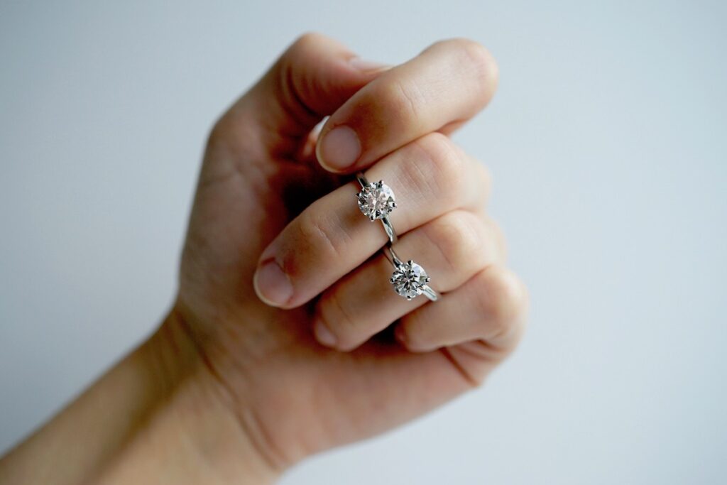 sustainably sourced natural and lab diamond engagement rings on a hand