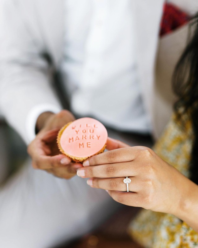 proposal idea couple holding cupcake that says will you marry me