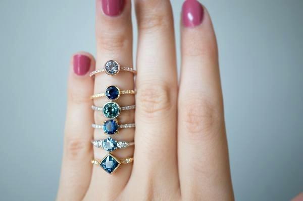 stack of montana sapphire engagement rings on ring finger in gold