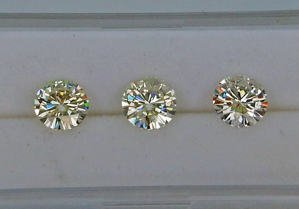 three round moissanite stones