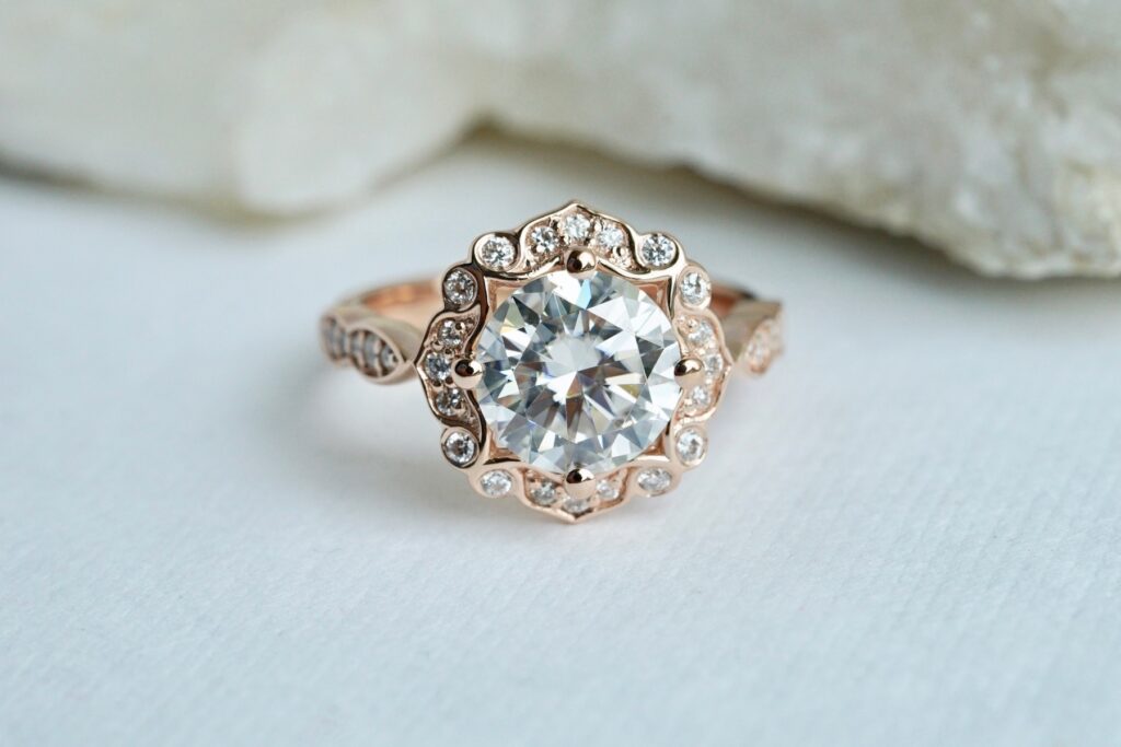 vintage halo engagement ring in rose gold with moissanite