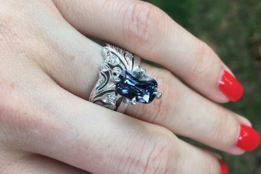 cushion cut dark blue gemstone engagement ring in white gold