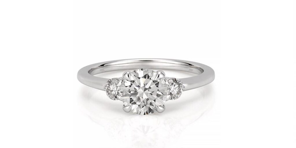 three stone engagement ring with round diamonds in white gold