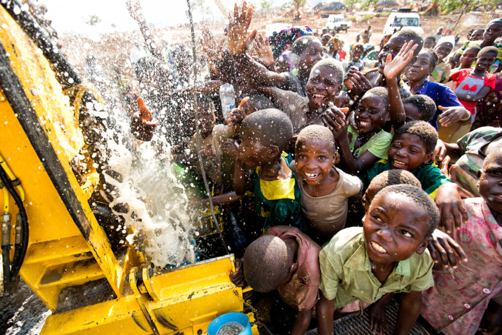 a new water well with the community celebrating a new water well