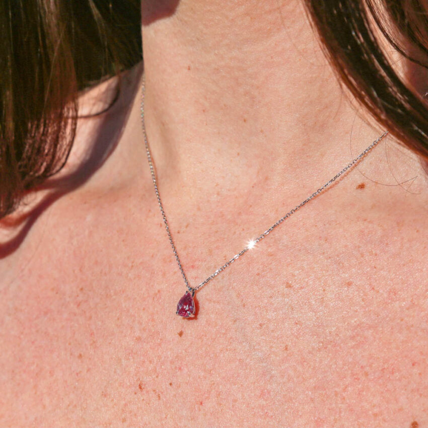 white gold necklace glistening in the sunlight with a pear shaped pendant