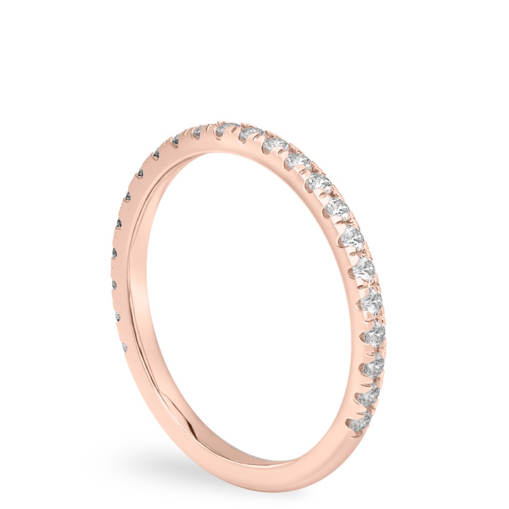 angle view of wedding band in rose gold with french pave diamonds