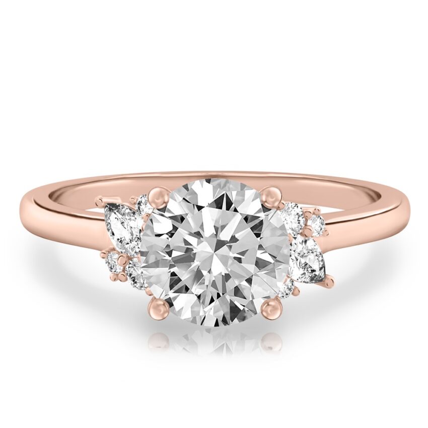 rose gold engagement ring with clusters of round and pear diamonds around the center stone