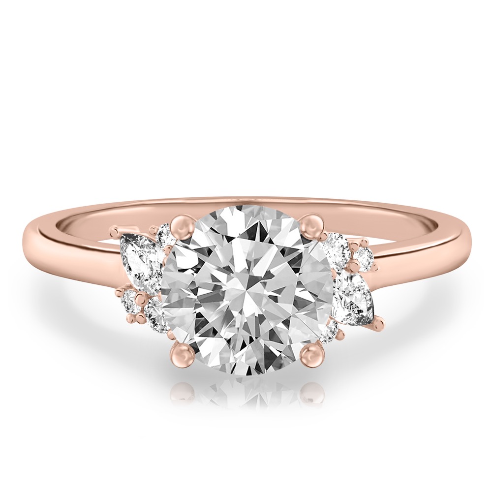 rose gold engagement ring with clusters of round and pear diamonds around the center stone