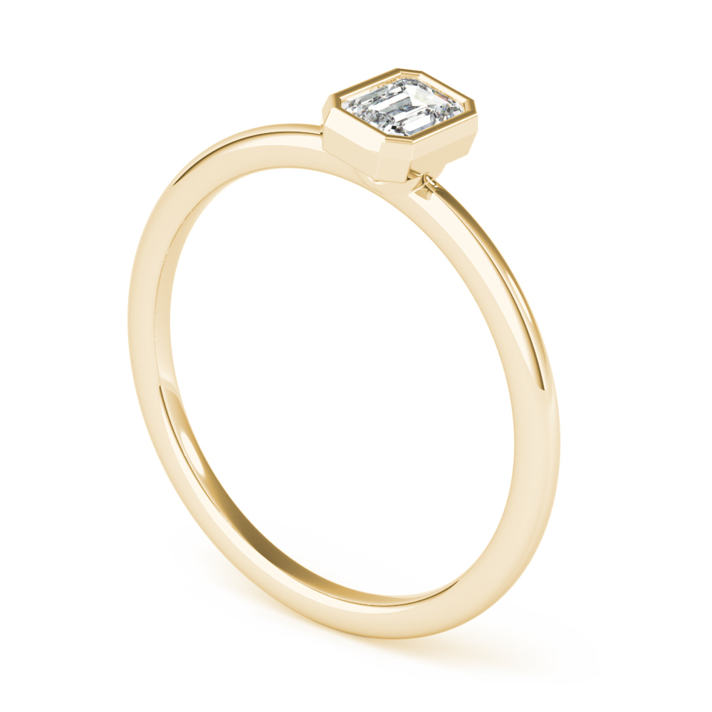 angle view of emerald bezel stackable rings yellow gold