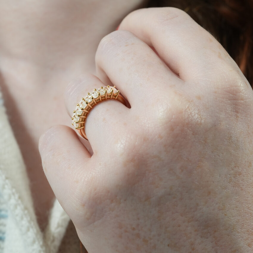 Angle view of emerald diamond anniversary band lifestyle