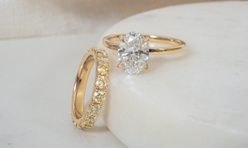 White diamond engagement ring with yellow diamond eternity band