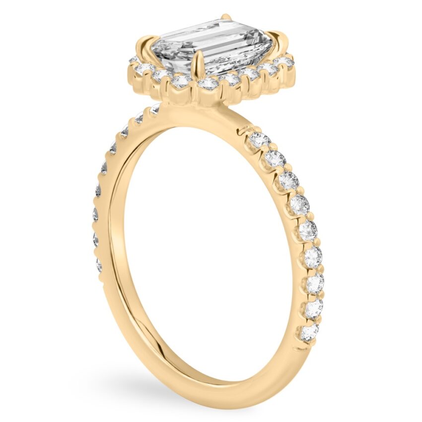 Angle view of emerald cut diamond scalloped halo engagement ring yellow gold