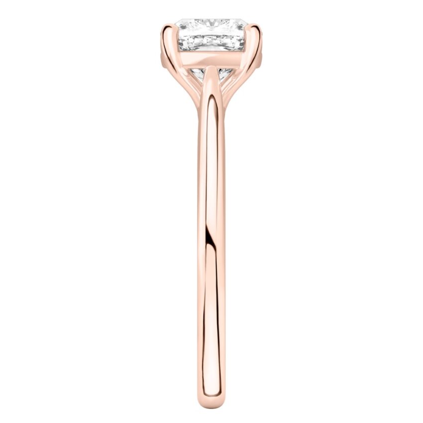 Side view of cushion cut diamond cathedral solitaire engagement ring rose gold