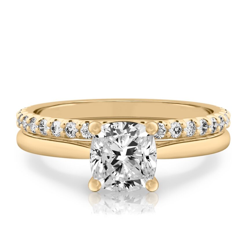 cushion cut diamond cathedral solitaire engagement ring set in yellow gold