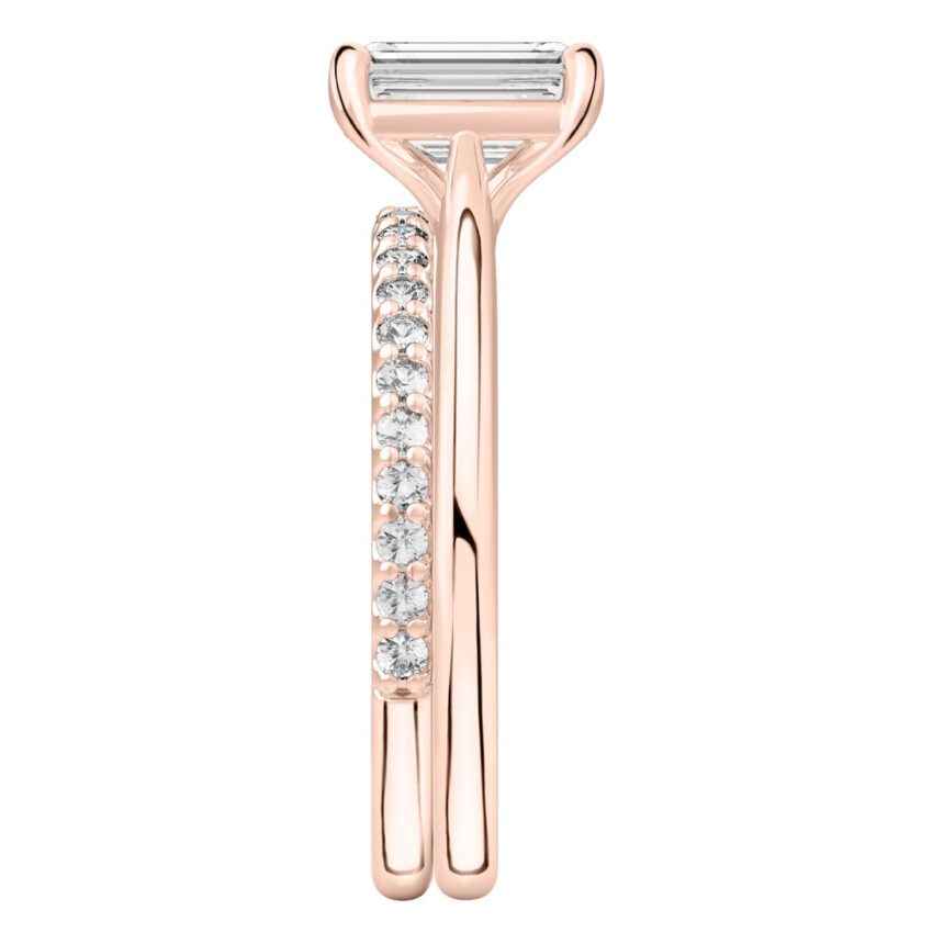 Side view of emerald cut diamond cathedral solitaire engagement ring set rose gold
