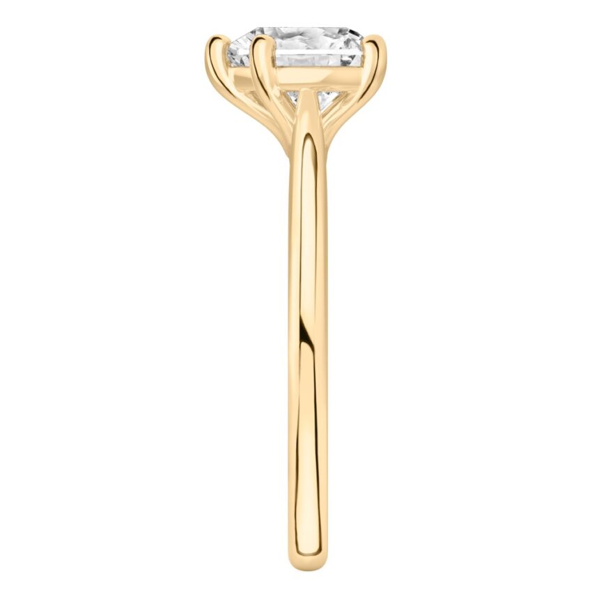Side view of heart shape diamond cathedral solitaire engagement ring yellow gold