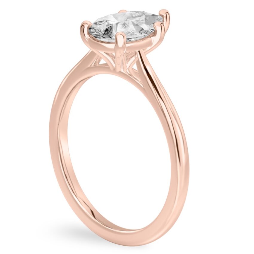 Angle view of pear shape diamond cathedral solitaire engagement ring rose gold