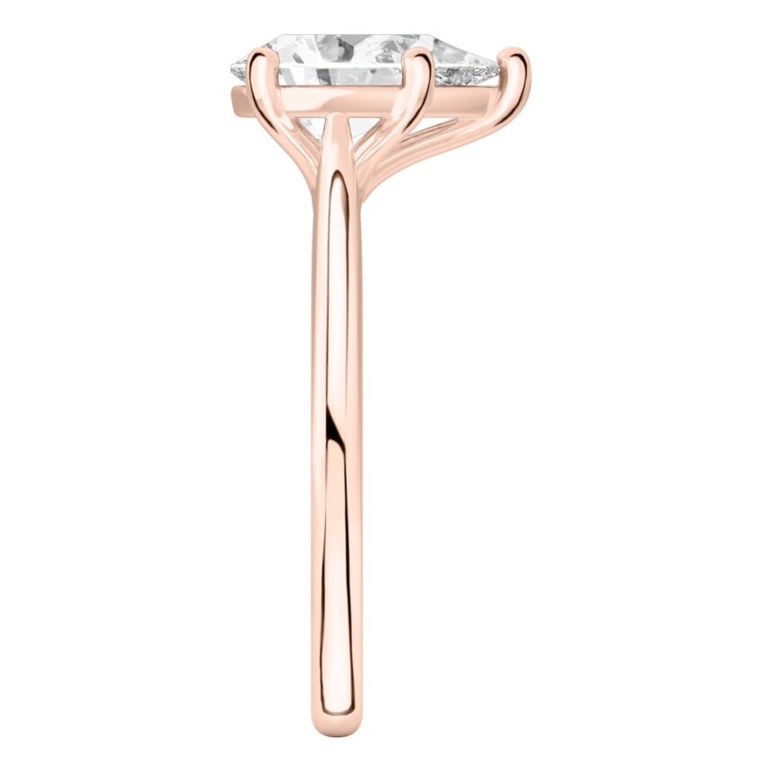 Side view of pear shape diamond cathedral solitaire engagement ring rose gold
