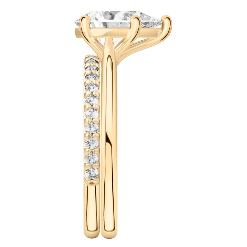 Side view of pear shape diamond cathedral solitaire engagement ring set yellow gold