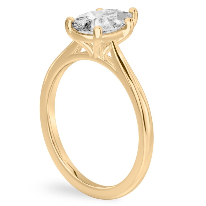 Angle view of pear shape diamond cathedral solitaire engagement ring yellow gold