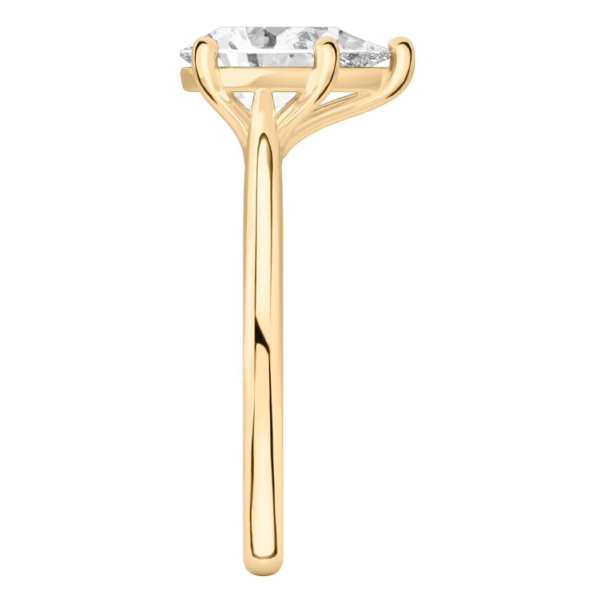 Side view of pear shape diamond cathedral solitaire engagement ring yellow gold