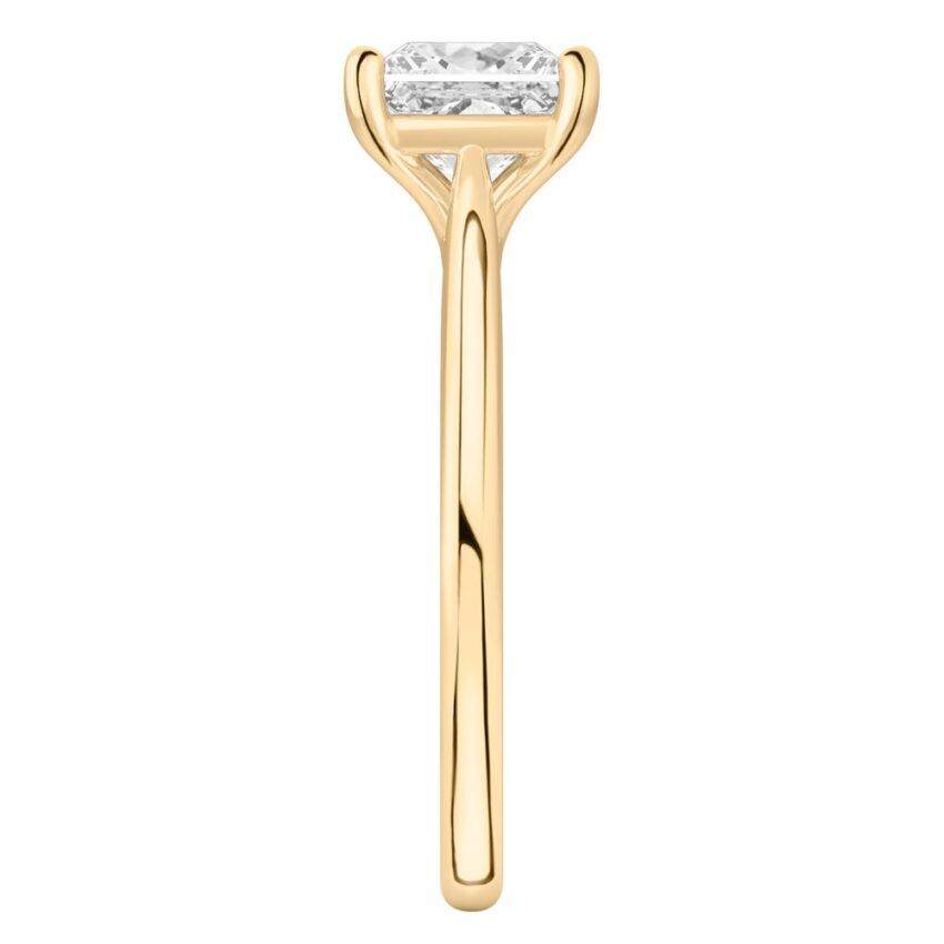 Side view of princess cut diamond cathedral solitaire engagement ring yellow gold
