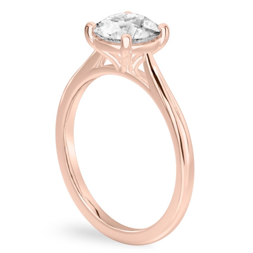 Angle view of round cut diamond cathedral solitaire engagement ring rose gold