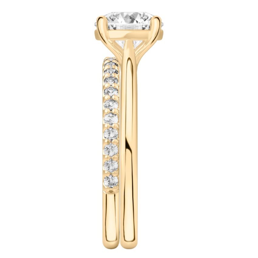 Side view of round cut diamond cathedral solitaire engagement ring set yellow gold