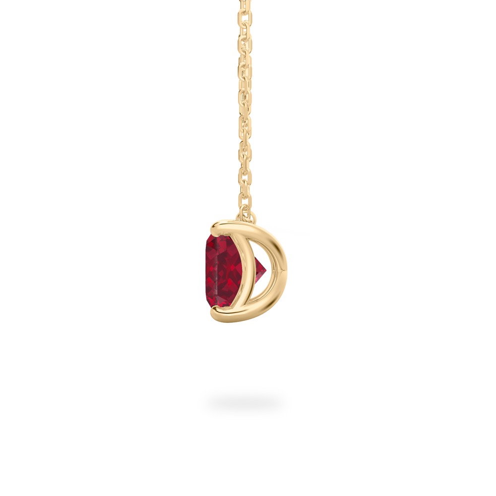side view of oval shape ruby necklace in yellow gold