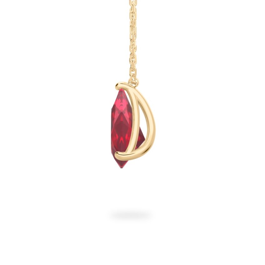 side view of pear shape ruby necklace in yellow gold