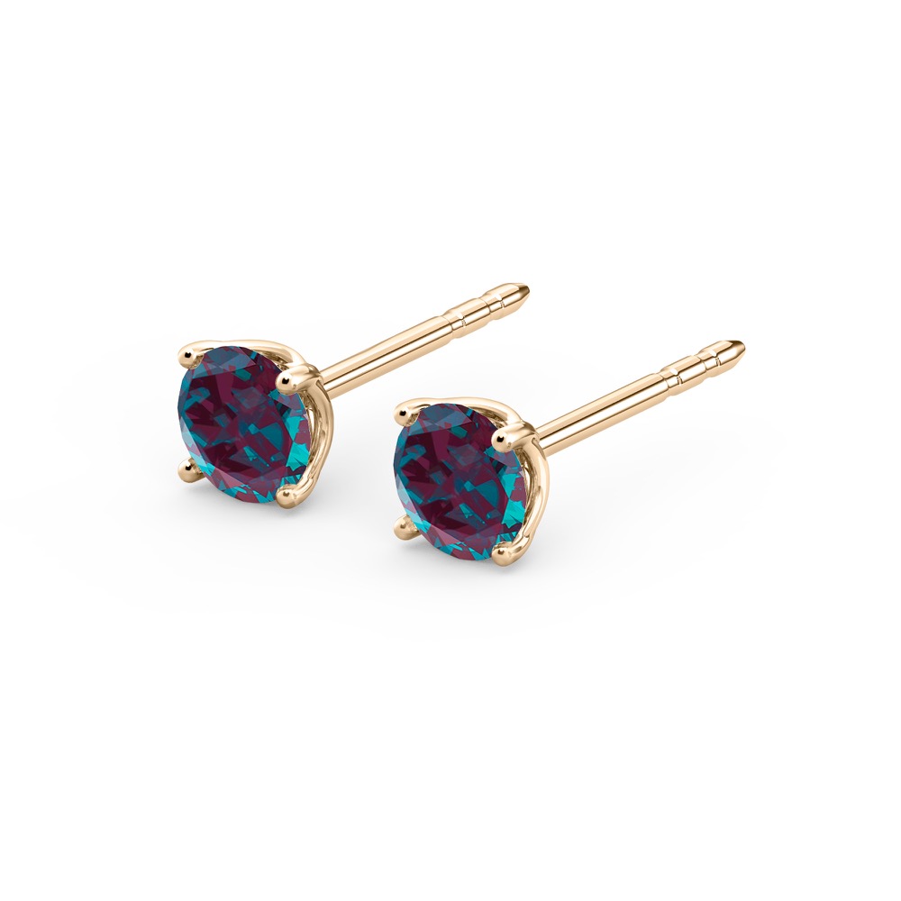 angle view of alexandrite earrings in yellow gold with round cut gemstone