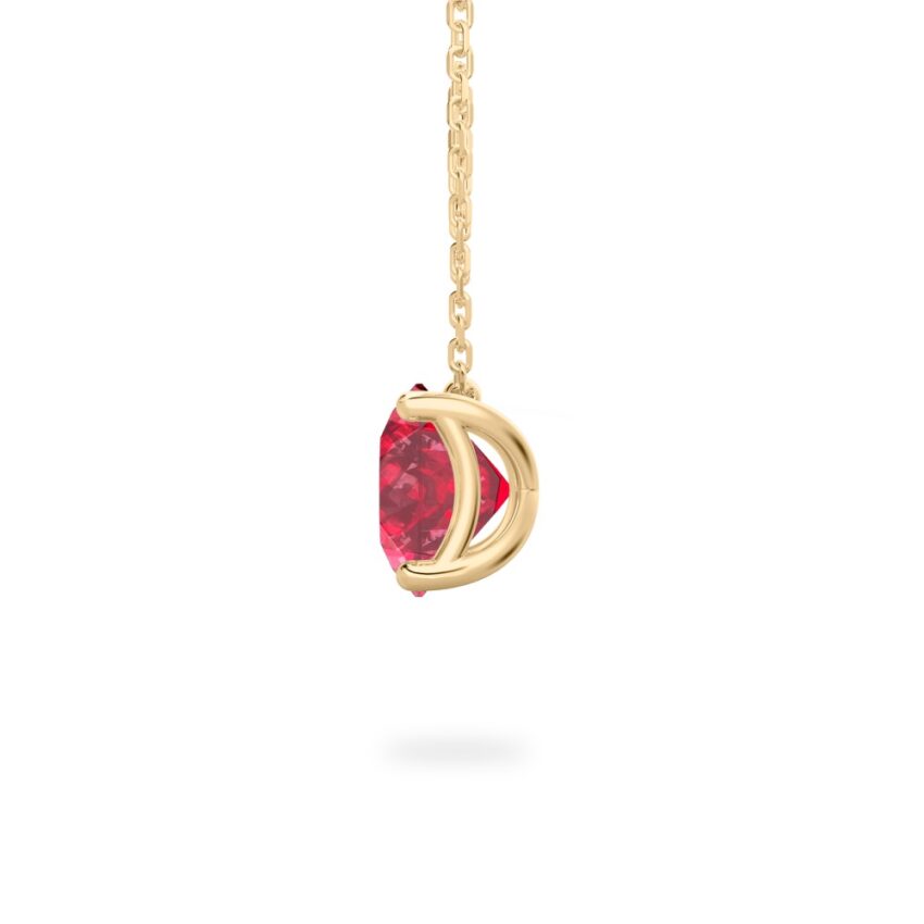 side view of round cut ruby necklace in yellow gold