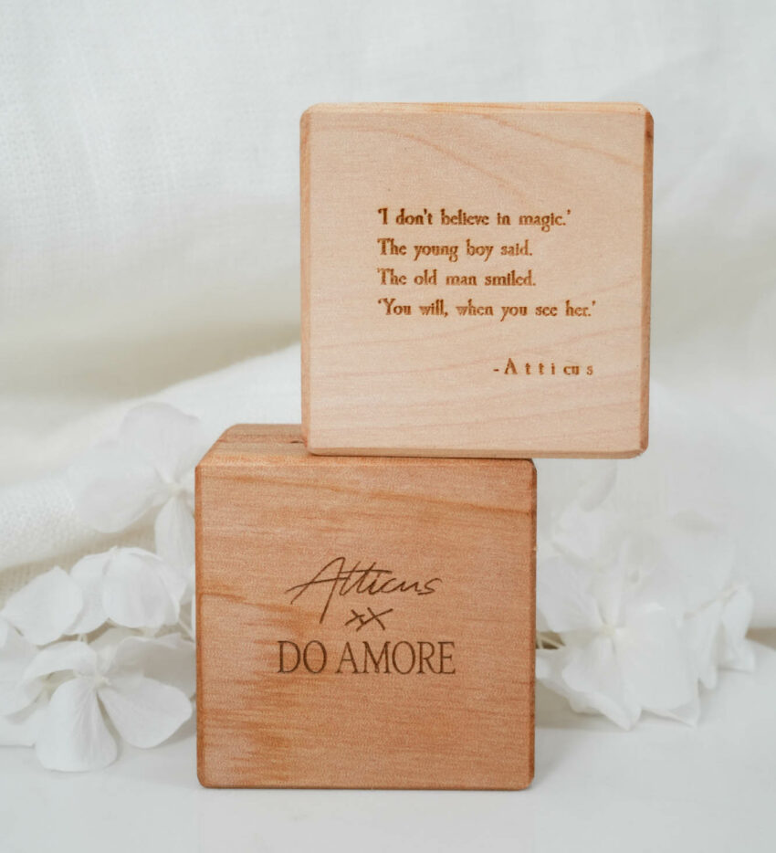 lifestyle image of wooden ring boxes stacked with magic poem engraved