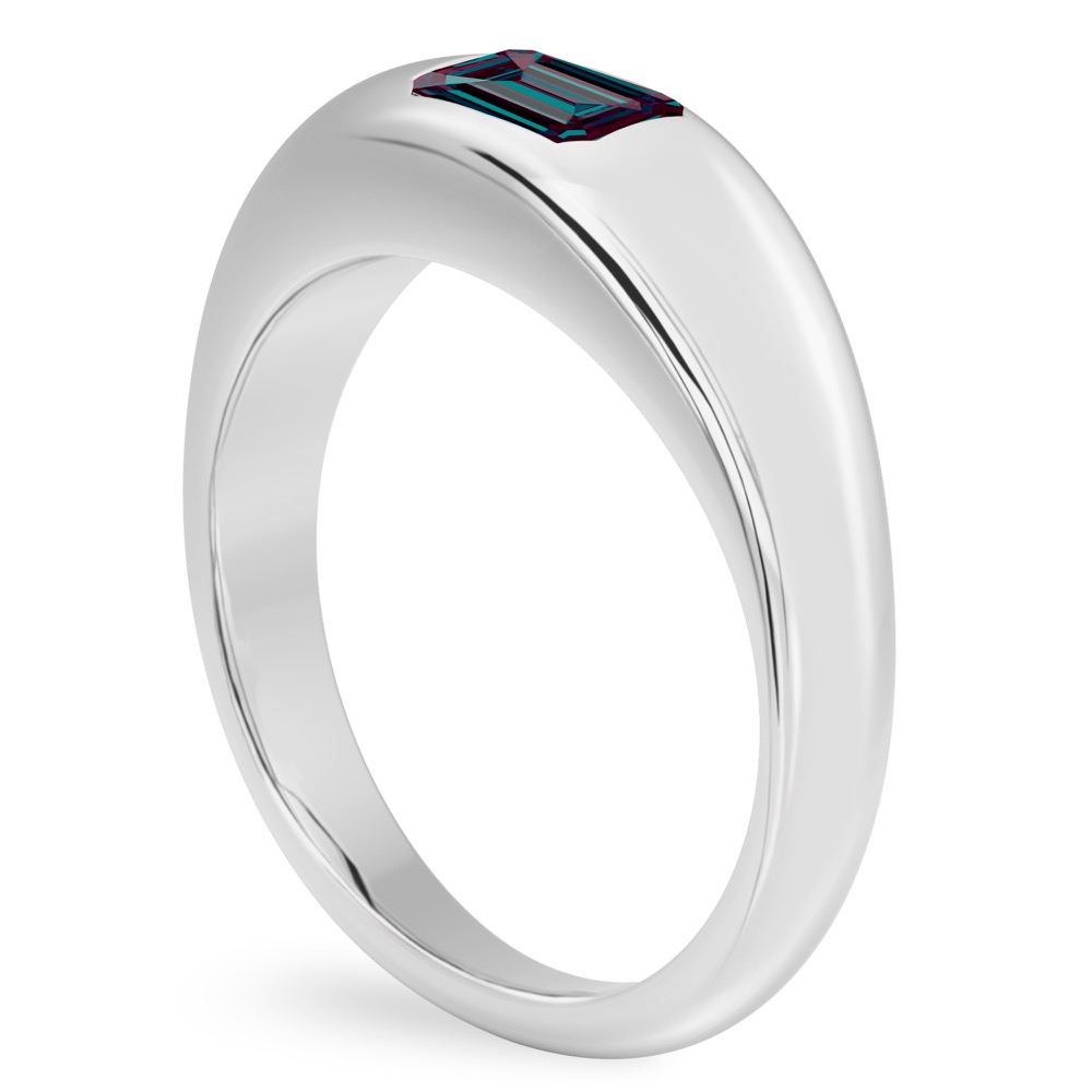 angle view of platinum dome ring with east west set emerald alexandrite gemstone