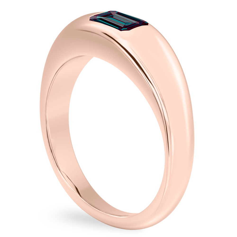 angle view of rose gold dome ring with east west set emerald alexandrite gemstone