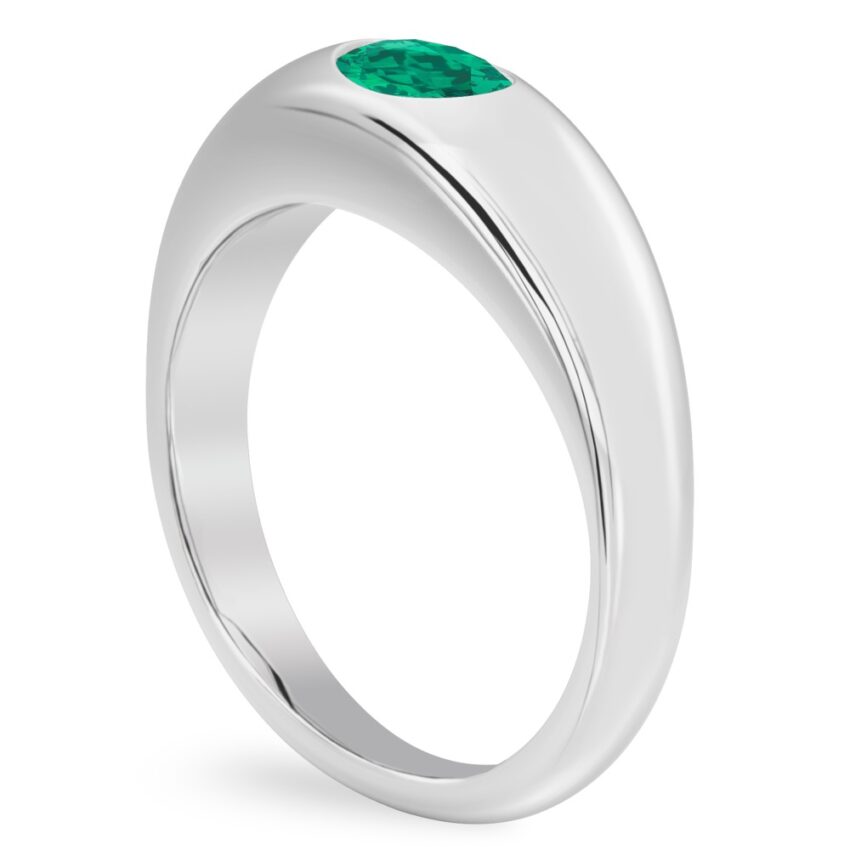 angle view of white gold dome ring with east west set oval emerald gemstone